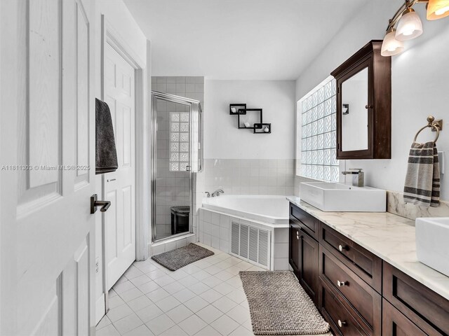 13381 SW 151st Ter, Miami, FL 33186 - bathroom featuring a garden tub, a stall shower, double vanity, and tile patterned flooring