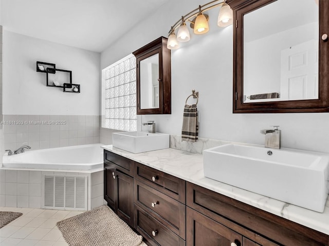 13381 SW 151st Ter, Miami, FL 33186 - bathroom with double vanity, a garden tub, and tile patterned flooring