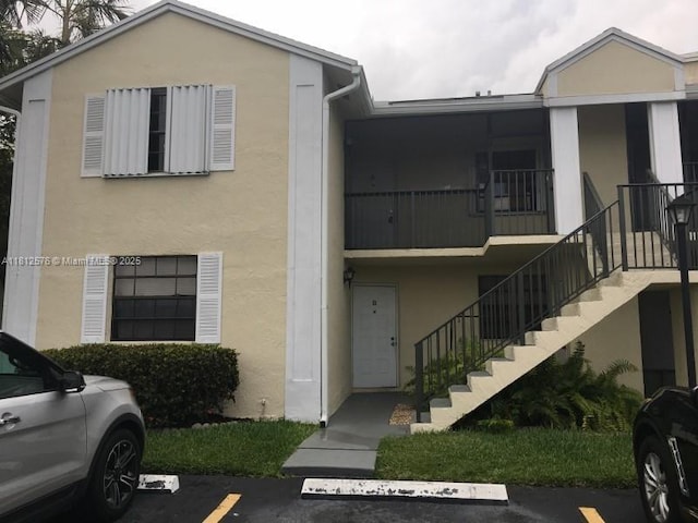 1061 Jefferson Dr Unit 1061B, Homestead, FL 33034 - view of property with stairs and uncovered parking