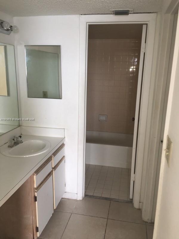 1061 Jefferson Dr Unit 1061B, Homestead, FL 33034 - full bath with vanity, tile patterned floors, and washtub / shower combination