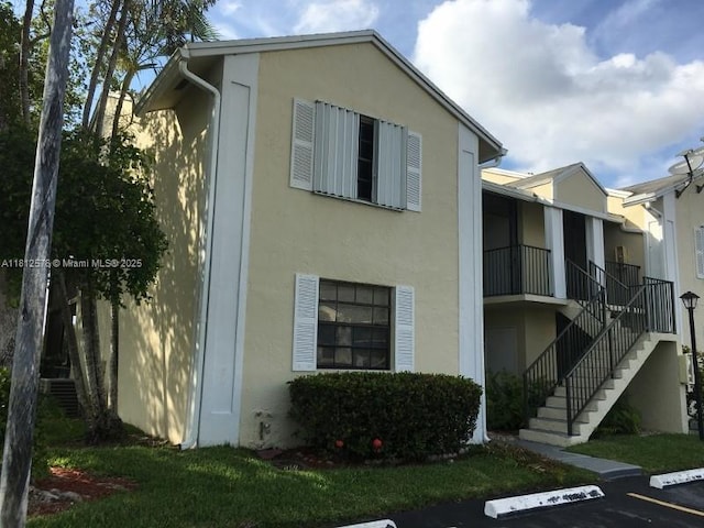 1061 Jefferson Dr Unit 1061B, Homestead, FL 33034 - view of building exterior featuring stairs and uncovered parking