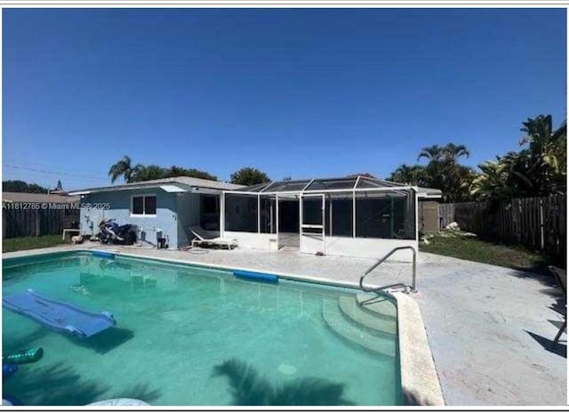 1601 SW 2nd Ave, Pompano Beach, FL 33060 - view of swimming pool featuring a fenced backyard, glass enclosure, and a patio area