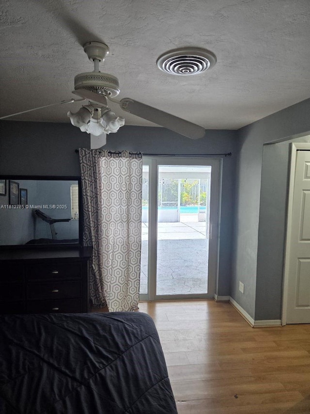 1601 SW 2nd Ave, Pompano Beach, FL 33060 - bedroom featuring access to exterior, light wood-style floors, and a textured ceiling