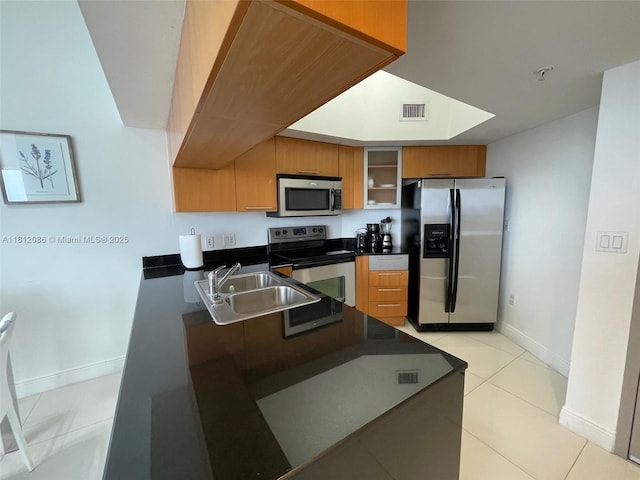 1750 N Bayshore Dr Unit 5615, Miami, FL 33132 - kitchen with stainless steel appliances, a sink, dark countertops, baseboards, and light tile patterned floors