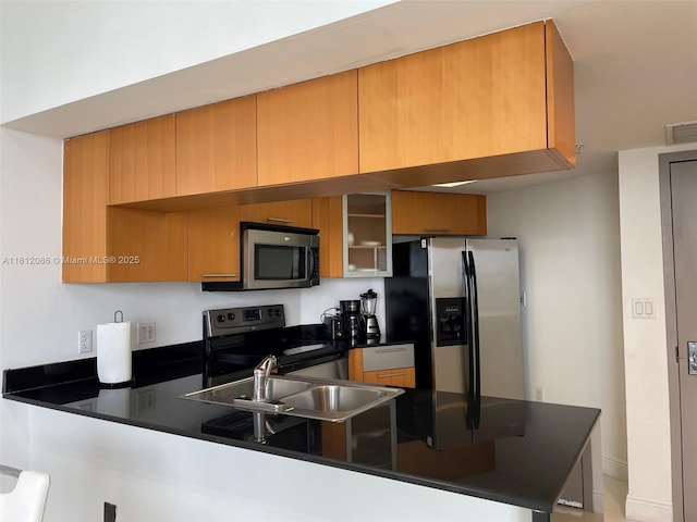 1750 N Bayshore Dr Unit 5615, Miami, FL 33132 - kitchen with stainless steel appliances, a peninsula, dark countertops, a sink, and brown cabinetry