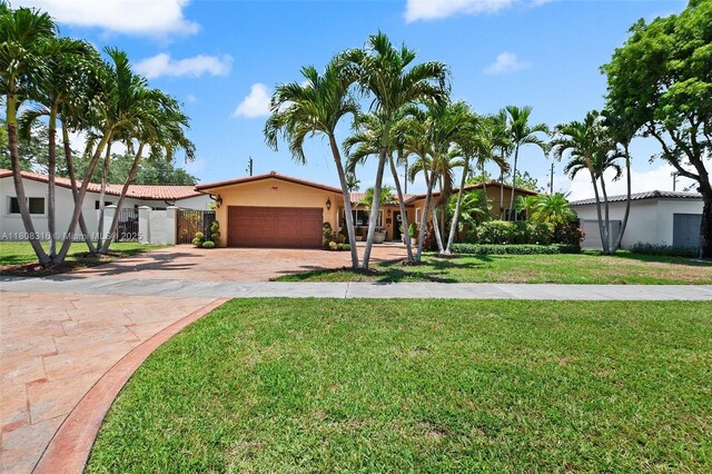 991 Dove Ave, Miami Springs, FL 33166 - view of front of property with decorative driveway, a garage, and stucco siding