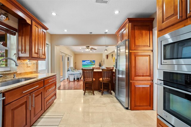 991 Dove Ave, Miami Springs, FL 33166 - kitchen featuring appliances with stainless steel finishes, a sink, recessed lighting, open floor plan, and a ceiling fan