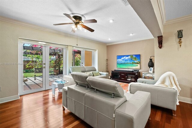 991 Dove Ave, Miami Springs, FL 33166 - living area featuring baseboards, wood finished floors, ceiling fan, ornamental molding, and a textured ceiling