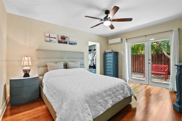 991 Dove Ave, Miami Springs, FL 33166 - bedroom featuring access to outside, an AC wall unit, wood finished floors, french doors, and a walk in closet
