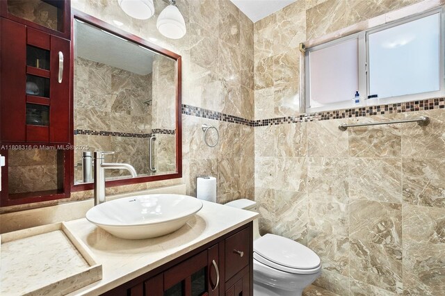 991 Dove Ave, Miami Springs, FL 33166 - bathroom with tile walls, vanity, and toilet