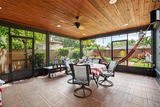 991 Dove Ave, Miami Springs, FL 33166 - sunroom / solarium featuring outdoor dining space, wood ceiling, and a ceiling fan