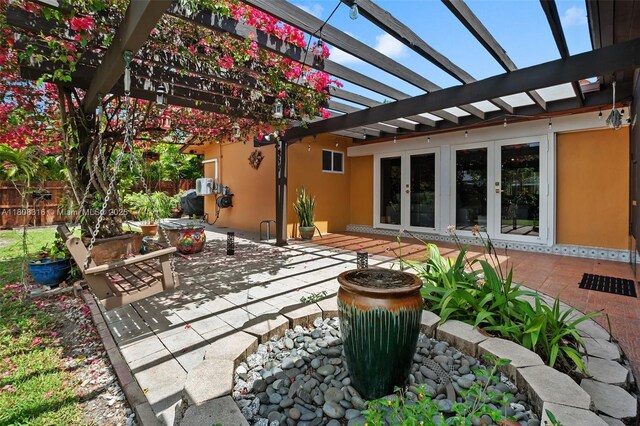 991 Dove Ave, Miami Springs, FL 33166 - view of patio featuring french doors and a pergola