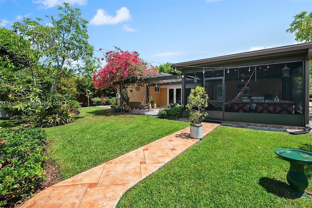 991 Dove Ave, Miami Springs, FL 33166 - view of grassy yard with a sunroom, a patio area, and french doors