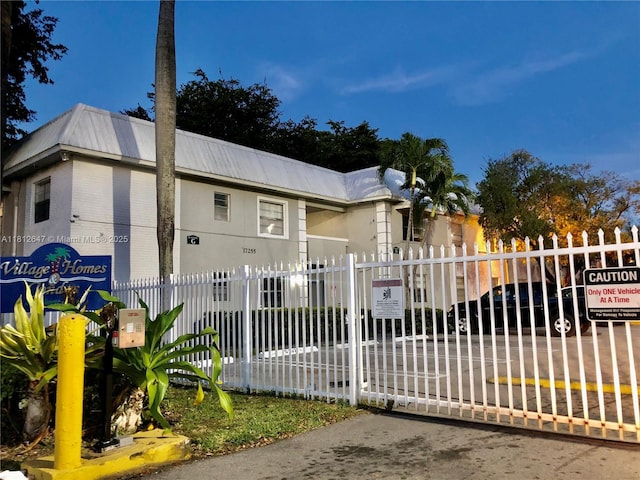 17255 SW 95th Ave Unit D-349, Palmetto Bay, FL 33157 - view of front facade featuring metal roof, a gate, and brick siding
