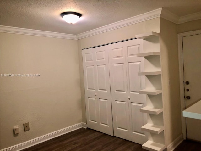 17255 SW 95th Ave Unit D-349, Palmetto Bay, FL 33157 - unfurnished bedroom with dark wood-type flooring, ornamental molding, a textured ceiling, a closet, and baseboards