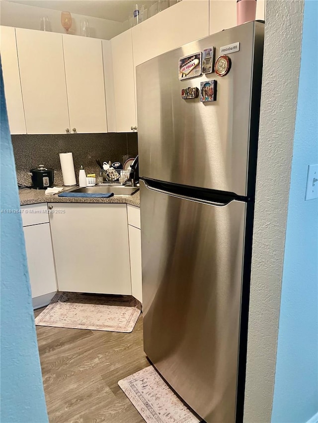 17255 SW 95th Ave Unit D-349, Palmetto Bay, FL 33157 - kitchen featuring freestanding refrigerator, wood finished floors, and white cabinets