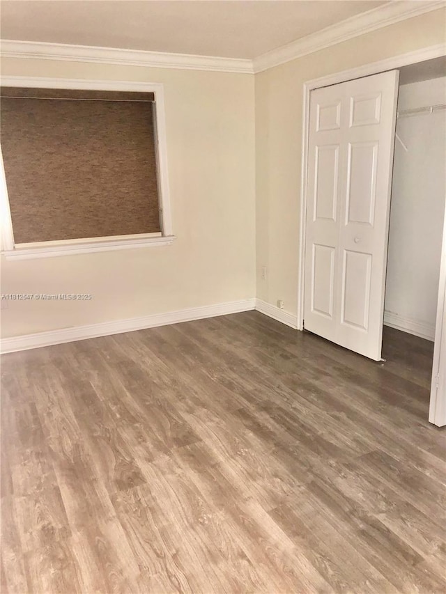 17255 SW 95th Ave Unit D-349, Palmetto Bay, FL 33157 - unfurnished bedroom featuring wood finished floors, ornamental molding, baseboards, and a closet