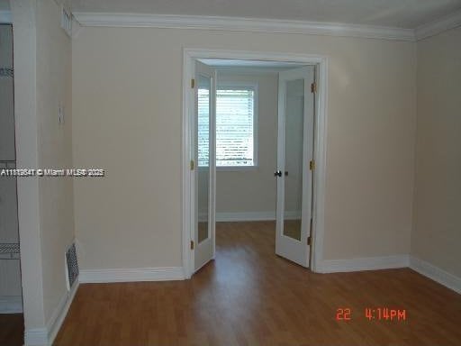 17255 SW 95th Ave Unit D-349, Palmetto Bay, FL 33157 - spare room with ornamental molding, wood finished floors, and baseboards