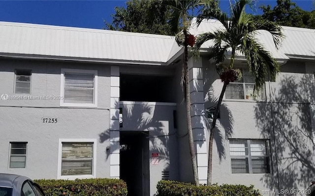 17255 SW 95th Ave Unit D-349, Palmetto Bay, FL 33157 - view of property exterior with stucco siding and a metal roof