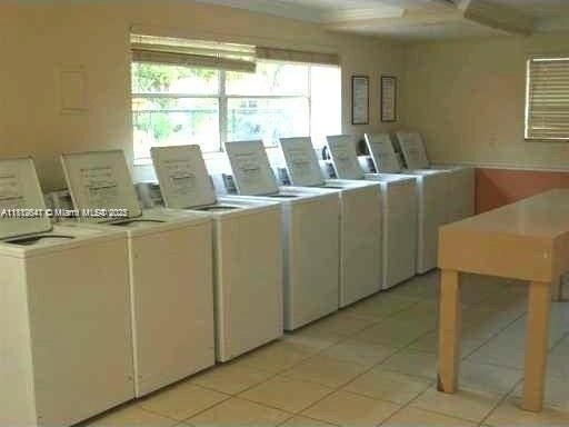 17255 SW 95th Ave Unit D-349, Palmetto Bay, FL 33157 - shared laundry featuring independent washer and dryer and light tile patterned flooring