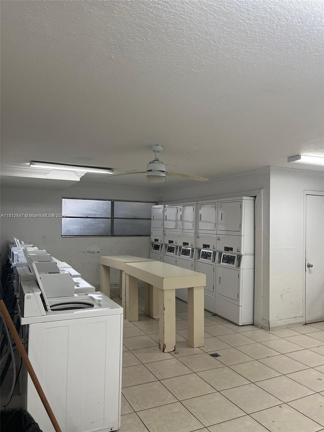 17255 SW 95th Ave Unit D-349, Palmetto Bay, FL 33157 - kitchen featuring light tile patterned floors, stacked washer / drying machine, a textured ceiling, and washer and clothes dryer