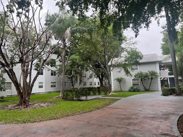 17255 SW 95th Ave Unit D-349, Palmetto Bay, FL 33157 - view of front of property featuring a front yard and a metal roof