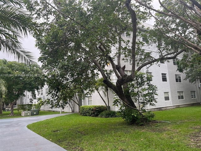 17255 SW 95th Ave Unit D-349, Palmetto Bay, FL 33157 - view of home's exterior featuring a lawn and stucco siding