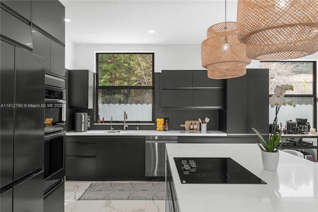 2320 SW 14th St, Miami, FL 33145 - kitchen with stainless steel appliances, modern cabinets, backsplash, light countertops, and recessed lighting