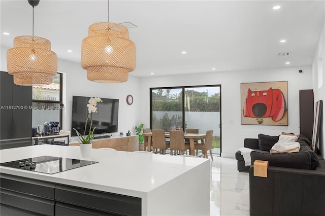2320 SW 14th St, Miami, FL 33145 - kitchen with open floor plan, light marble finish flooring, black electric cooktop, recessed lighting, and light countertops