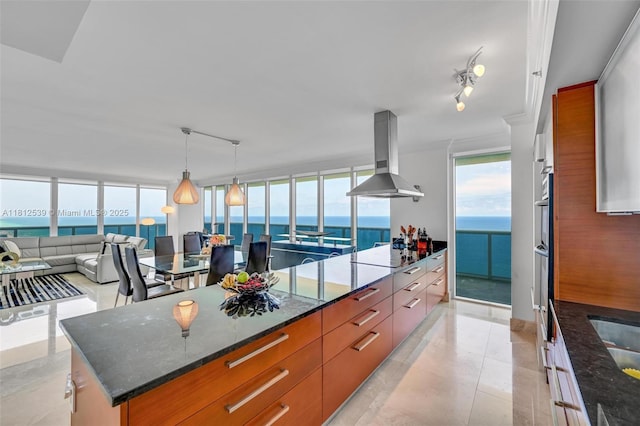 1830 S Ocean Dr Unit 3801, Hallandale Beach, FL 33009 - kitchen featuring rail lighting, island range hood, black electric cooktop, and plenty of natural light