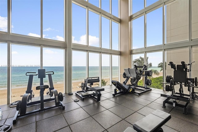 1830 S Ocean Dr Unit 3801, Hallandale Beach, FL 33009 - workout area featuring view of water and beach, a high ceiling, and a wall of windows
