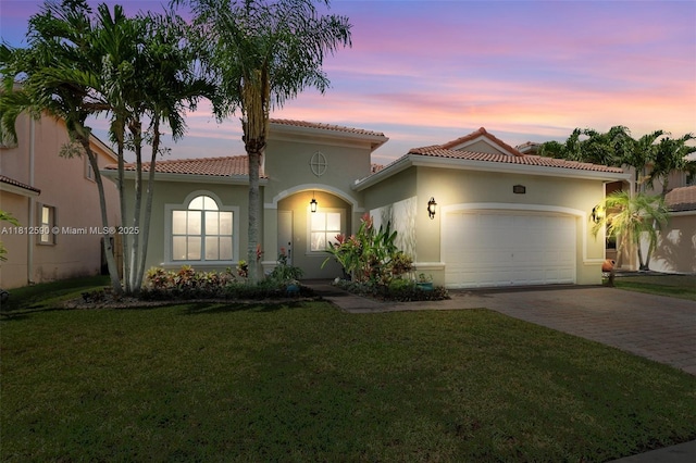 2046 SE 18th St, Homestead, FL 33035 - mediterranean / spanish-style home with driveway, an attached garage, stucco siding, a yard, and a tiled roof