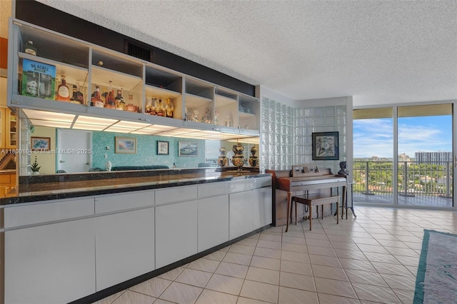 4000 Towerside Ter Unit 1403, Miami, FL 33138 - bar with a textured ceiling and a wall of windows