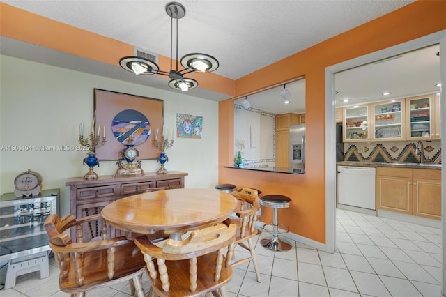 4000 Towerside Ter Unit 1403, Miami, FL 33138 - dining space featuring light tile patterned floors, a chandelier, a textured ceiling, and baseboards