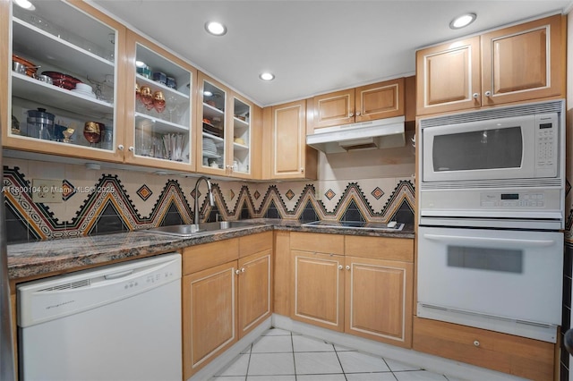4000 Towerside Ter Unit 1403, Miami, FL 33138 - kitchen featuring white appliances, a sink, under cabinet range hood, light tile patterned floors, and glass insert cabinets
