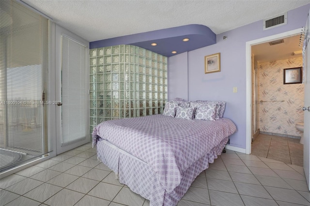 4000 Towerside Ter Unit 1403, Miami, FL 33138 - bedroom featuring light tile patterned floors, a textured ceiling, and baseboards