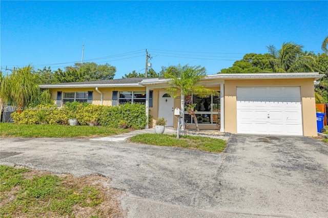 4051 NE 17th Ter, Pompano Beach, FL 33064 - ranch-style home with stucco siding and asphalt driveway