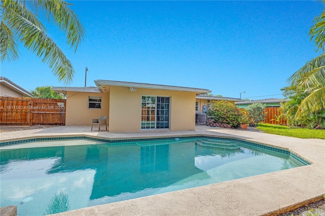 4051 NE 17th Ter, Pompano Beach, FL 33064 - view of swimming pool with central air condition unit and a patio