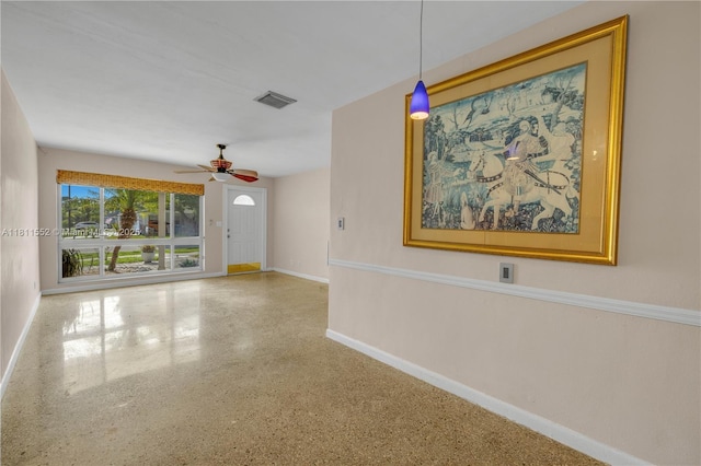 4051 NE 17th Ter, Pompano Beach, FL 33064 - unfurnished living room with a ceiling fan, baseboards, and speckled floor