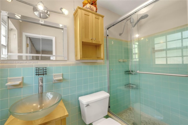 4051 NE 17th Ter, Pompano Beach, FL 33064 - bathroom with a shower stall, toilet, vanity, and tile walls