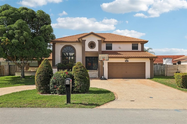 15050 E Falcons Lea Dr, Davie, FL 33331 - mediterranean / spanish house featuring stucco siding, driveway, a tile roof, and an attached garage