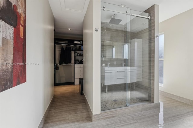 15050 E Falcons Lea Dr, Davie, FL 33331 - bathroom featuring a stall shower, a spacious closet, and baseboards
