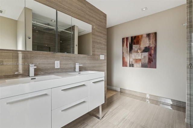 15050 E Falcons Lea Dr, Davie, FL 33331 - full bathroom featuring double vanity, tasteful backsplash, a shower stall, and baseboards