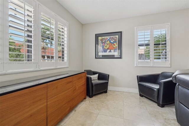 15050 E Falcons Lea Dr, Davie, FL 33331 - sitting room featuring baseboards and light tile patterned floors