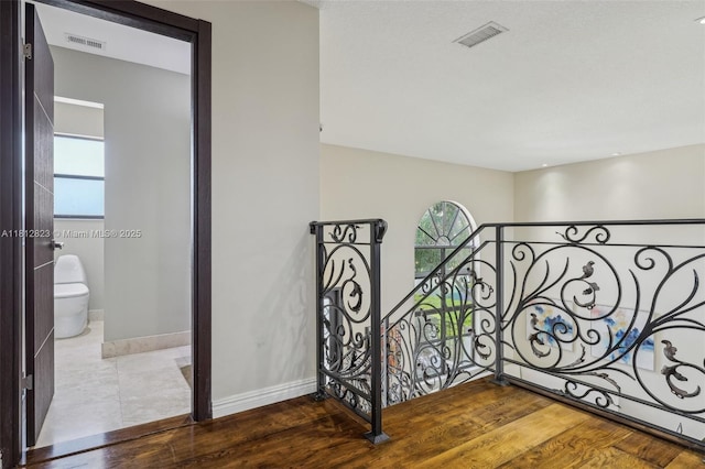 15050 E Falcons Lea Dr, Davie, FL 33331 - hallway with wood finished floors, an upstairs landing, and baseboards