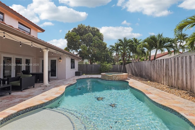15050 E Falcons Lea Dr, Davie, FL 33331 - view of swimming pool featuring a fenced backyard, a patio area, and a pool with connected hot tub