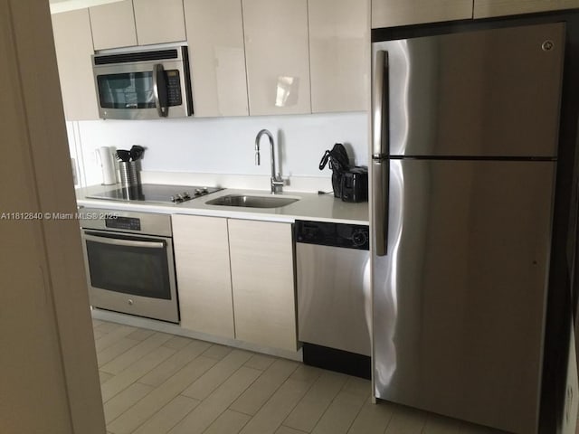 2602 E Hallandale Beach Blvd Unit R2010, Hallandale Beach, FL 33009 - kitchen featuring appliances with stainless steel finishes, a sink, light countertops, and modern cabinets