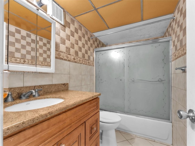 1849 SW 81st Way Unit 1-24, Davie, FL 33324 - bathroom featuring tile walls, vanity, washtub / shower combination, toilet, and tile patterned flooring