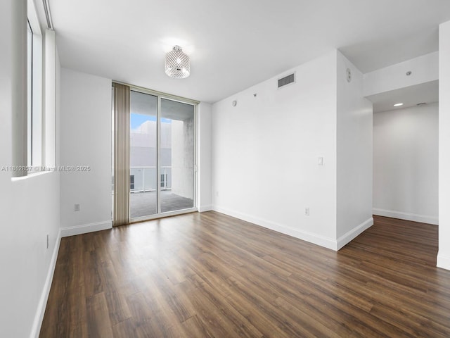 253 NE 2nd St Unit 3108, Miami, FL 33132 - spare room with expansive windows, dark wood finished floors, and baseboards