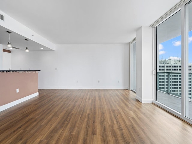 253 NE 2nd St Unit 3108, Miami, FL 33132 - unfurnished room featuring wood finished floors, baseboards, and a wall of windows